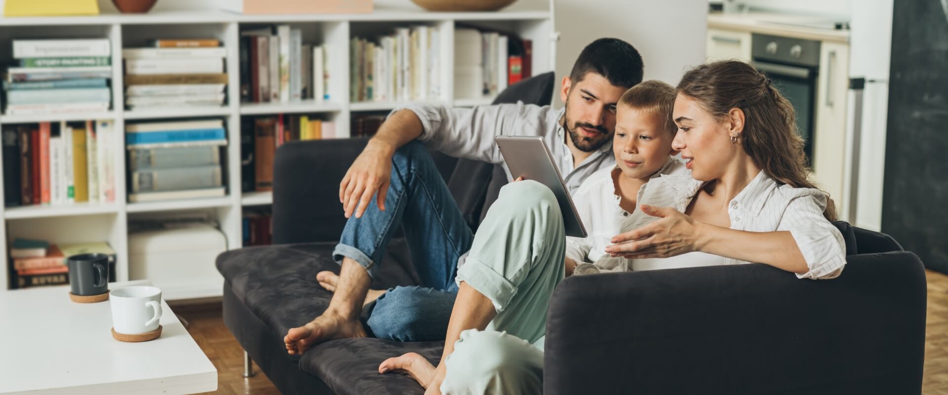 Young Happy family Sitting on Sofa