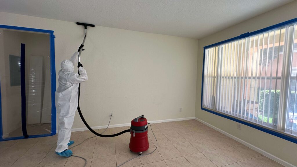 Professional Mold Remediation in West Palm Beach, FL 14 A person in a white suit is painting a room after mold cleaning, ensuring a fresh and safe environment.