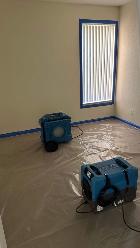 Professional Mold Remediation in West Palm Beach, FL 8 A room featuring a vacuum and a bucket, prepared for mold cleaning tasks.